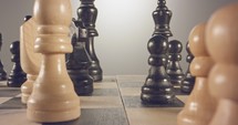 Tracking macro shot moving between chess pieces on a chess board.