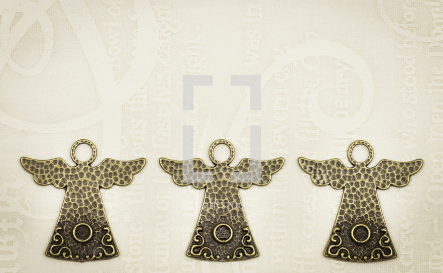 Three Christmas angels on creamy text background