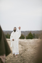 Jesus waving to his disciples.
