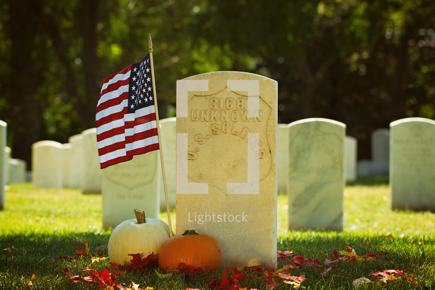 an American flag at a grave site 