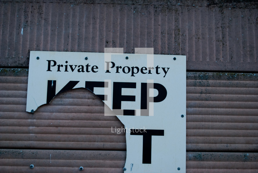 torn private property keep out sign