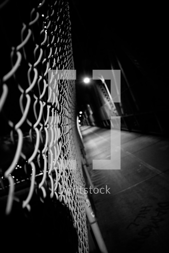chain link fence in a dark alley 