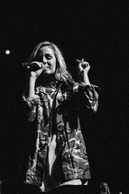 teen girl singing into a microphone 