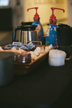 sugar, creamer, and stirrers in a basket at a coffee shop 