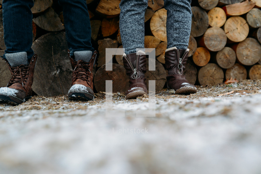boots and a stack of firewood 