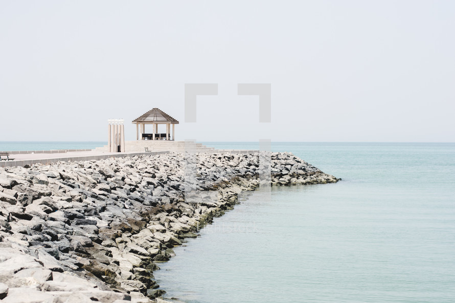 pergola on a jetty along a coastline in the middle east 