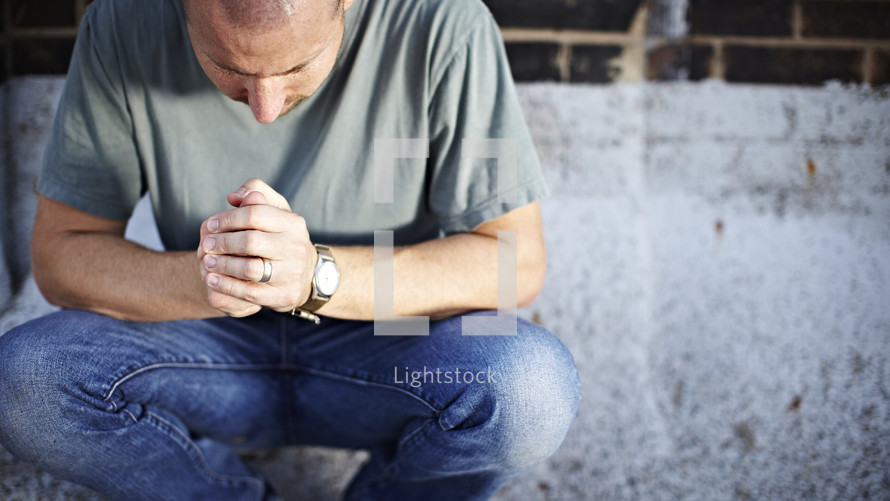 Man kneeling in prayer