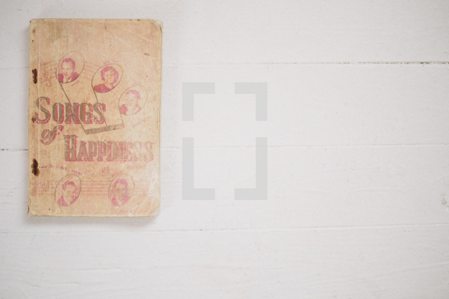Songs of Happiness, an old worn book 