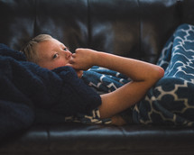 a child napping on a couch 