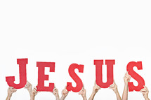 word JESUS held up by hands