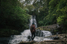 backpacking near a waterfall in New Zealand 