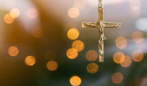 cross and blurry bokeh lights background 
