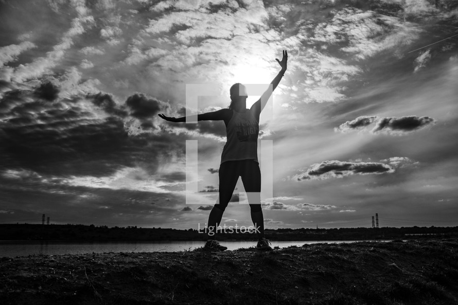 a woman exercising near a lake shore 
