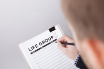 A Man Signing Up for Life Groups