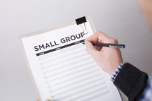 A man signing up to be in a small group 