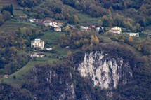 homes on a green slope on a mountainside 