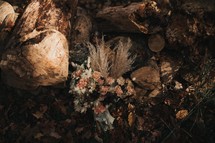 a bridal bouquet and a pile of logs 