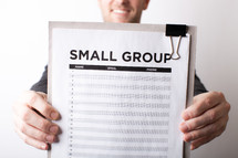 A Man with a Small Group Sign Up Sheet