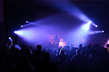 spot lights shining on musicians on stage at a concert 