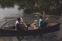 couple and a dog in a boat 