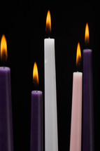 advent candles against a black background 