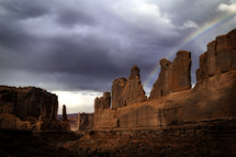 The rainbow appears after the storm over the viewpoint of Park ave in Arches National Park