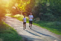 couple jogging on a path 