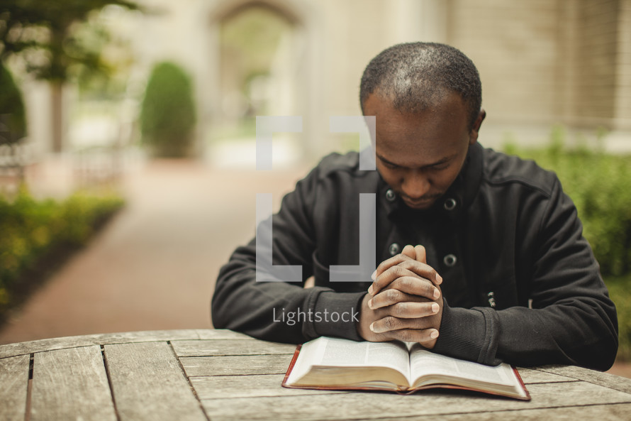 Man in prayer with bible