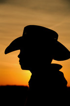 Silhouette of boy in cowboy hat 