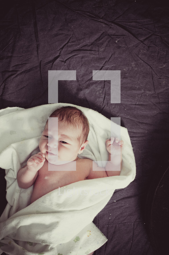 infant swaddled in a blanket