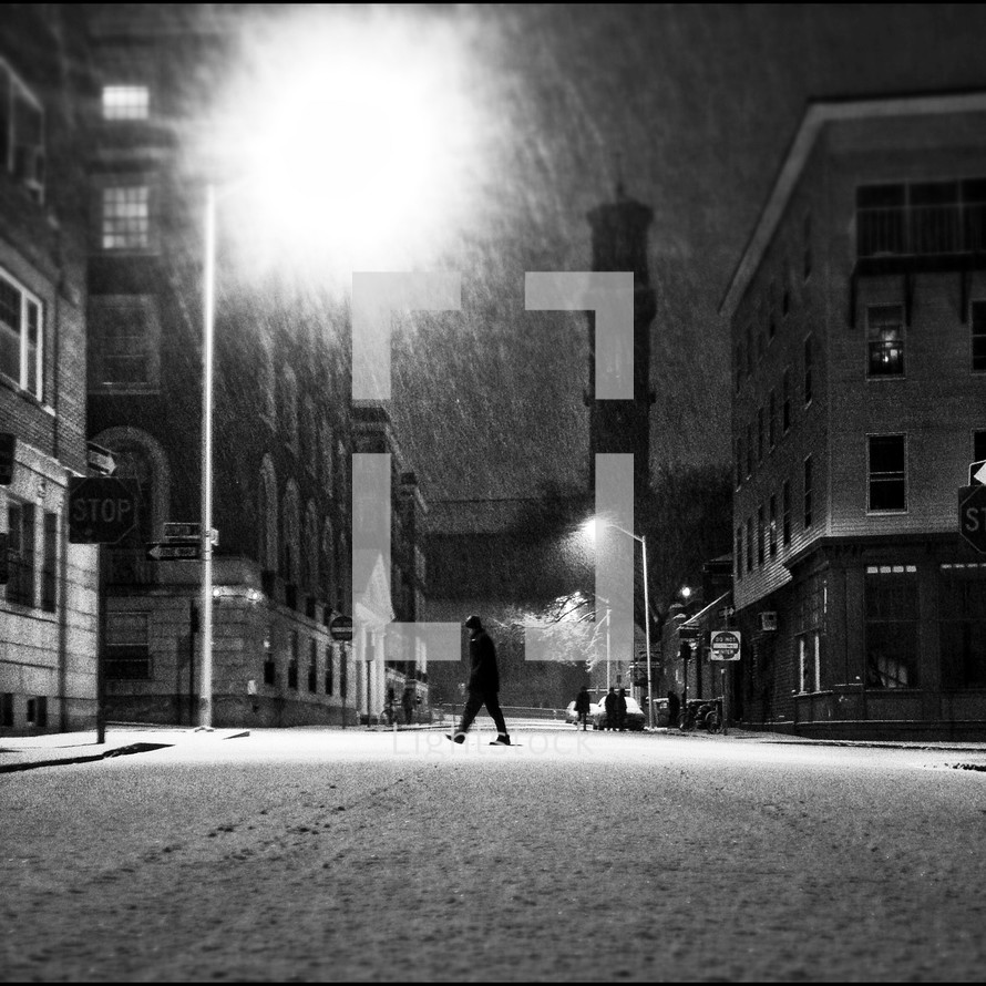 Man walking across street in snow