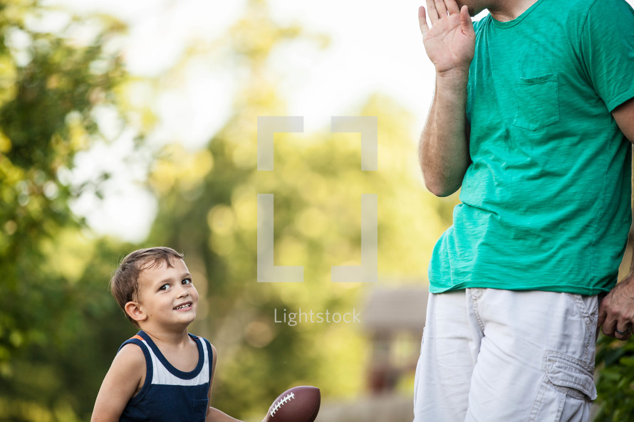 father and son with a football 