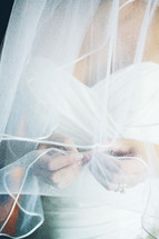 bride touching her veil 