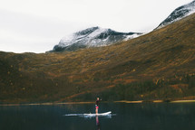 man on a paddle board on a lake 