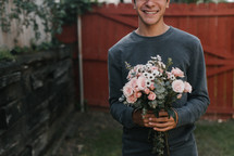 a man holding a bouquet of flowers 