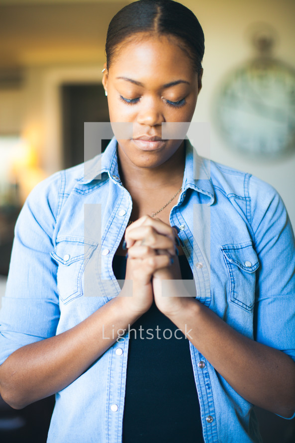 woman in prayer with praying hands 