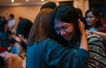 hugs and tears at a worship service 