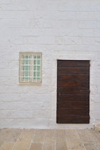 Traditional facade of south adriatic sea house with door and window minimalist decorated in small village of Monopoli, south Italy