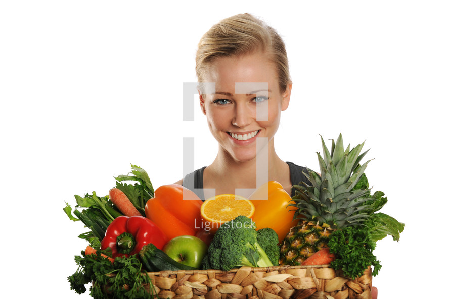 woman holding a basket of fruits and vegetables 