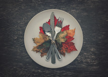 silverware on leaves on a plate fall dinner party place setting 