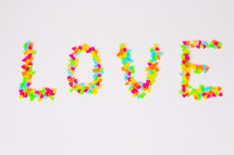 word love in colorful heart shaped candy 