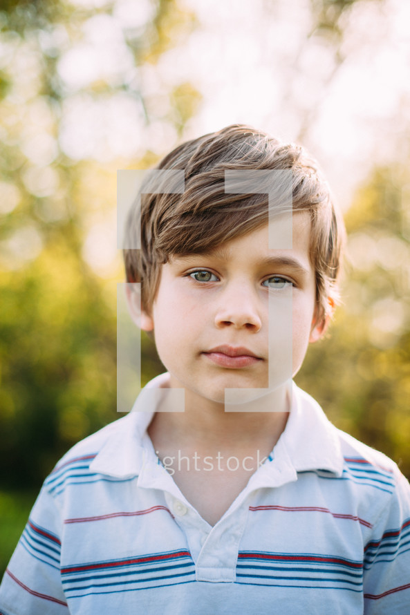 headshot of a boy outdoors 