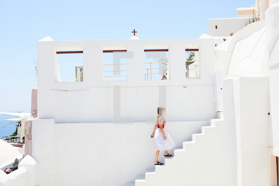 woman walking up steps in Greece 
