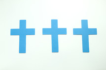 three blue crosses on a white background 