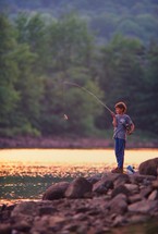 boy fishing on a shore 