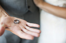 groom holding rings in his hand