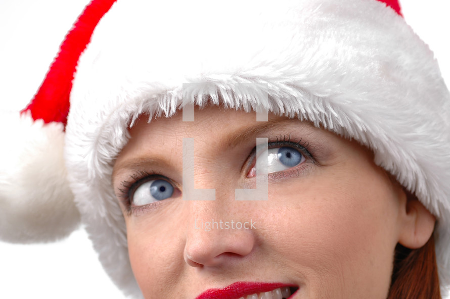 eyes of a woman in a santa hat 