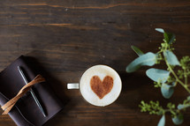 cinnamon heart in a coffee cup, Leather bound Bible, and house plant 
