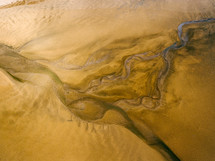aerial view above sand and water below 