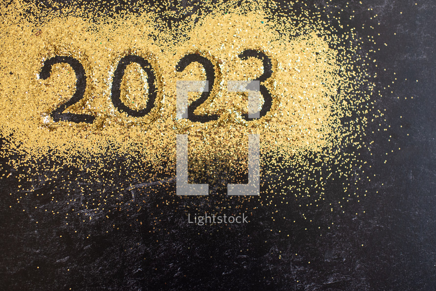 Gold glitter with the year 2023 written in it